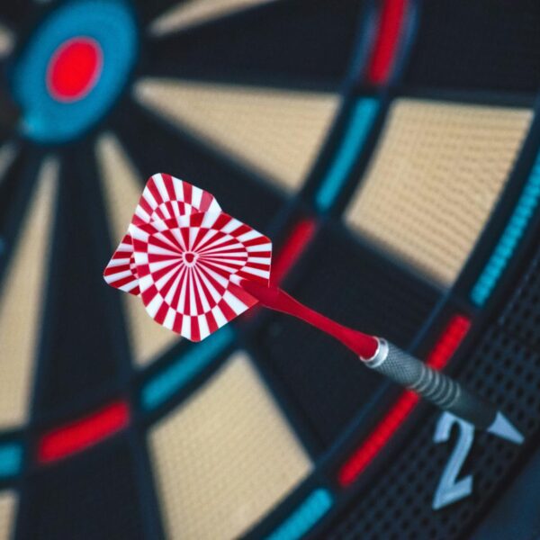 Red and white dart on a dartboard